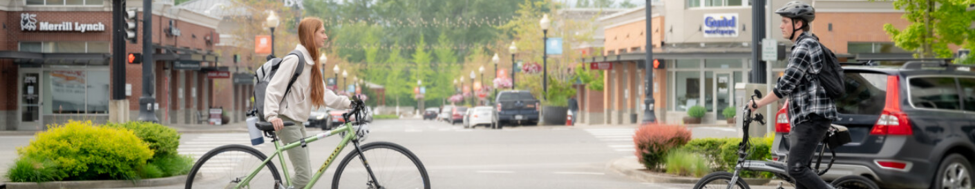 Two people walking bikes