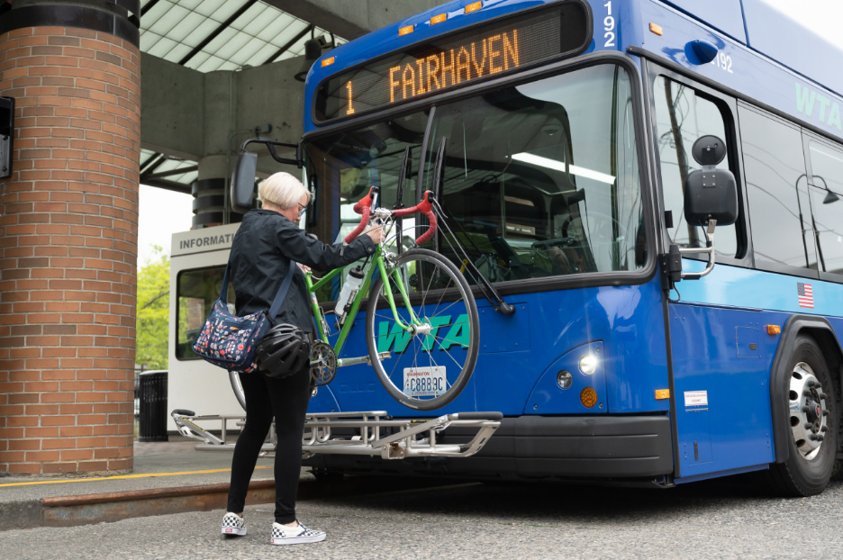 Person loading bike on bus